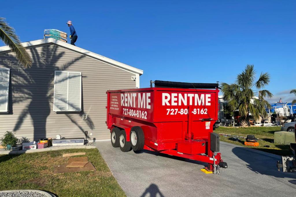 Big red dumpster rental St Petersburg FL parked at a roofing jobsite. 